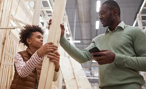 father and son gathering supplies at a home improvement store